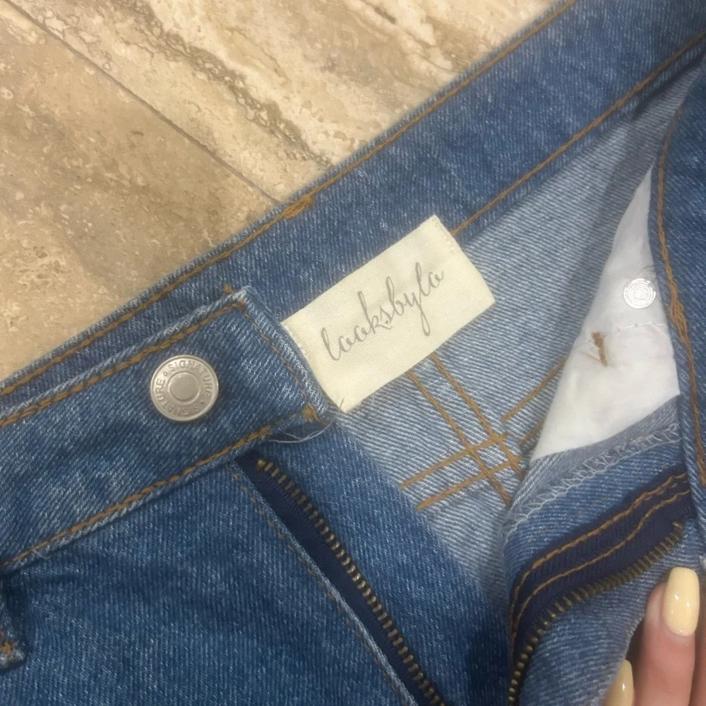 Denim Skirt with Lace-Up Detail fits like a medium